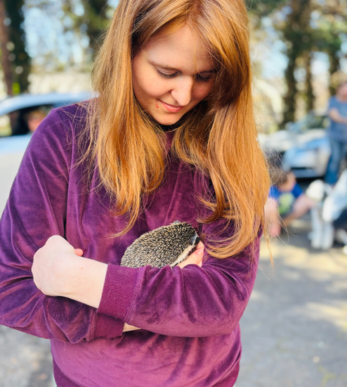 student with a hedgehog
