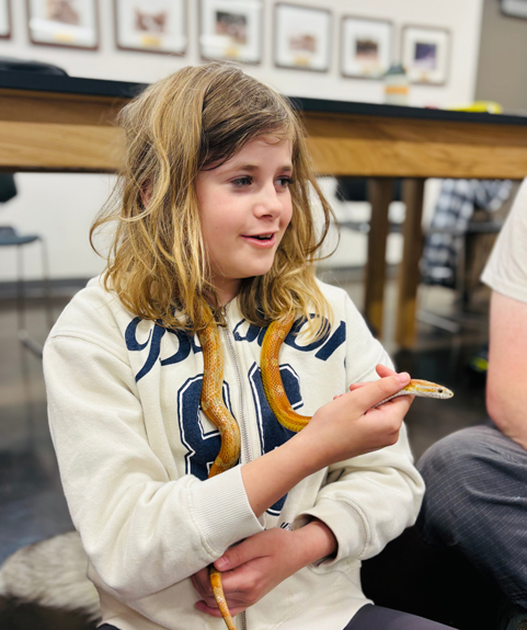 student holding a snake