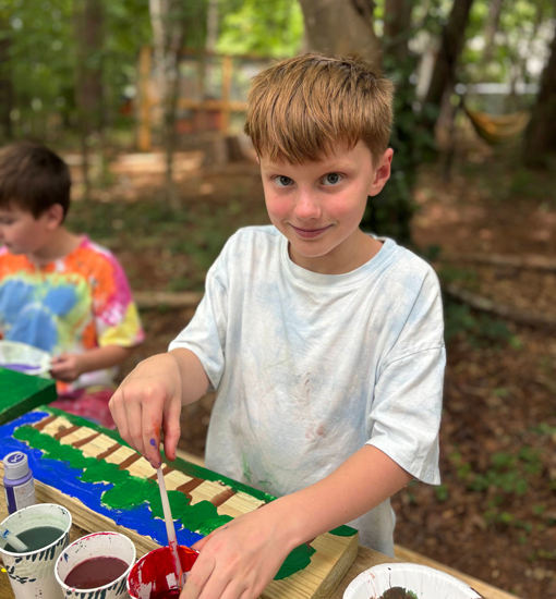 boy painting trees