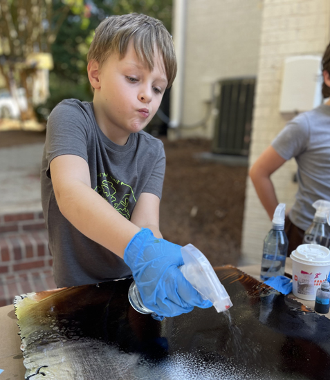 boy using spray bottle