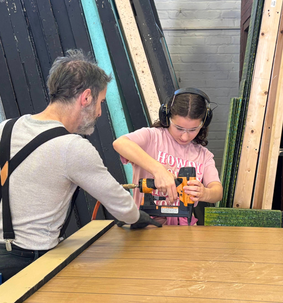 student drilling into wood