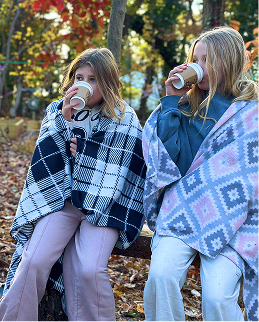 two students sipping hot chocolate 