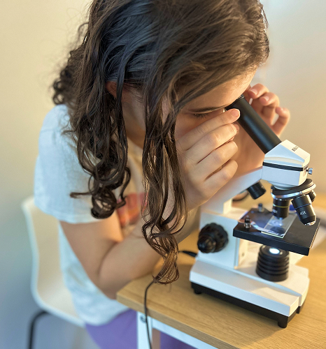 student using a telescope 