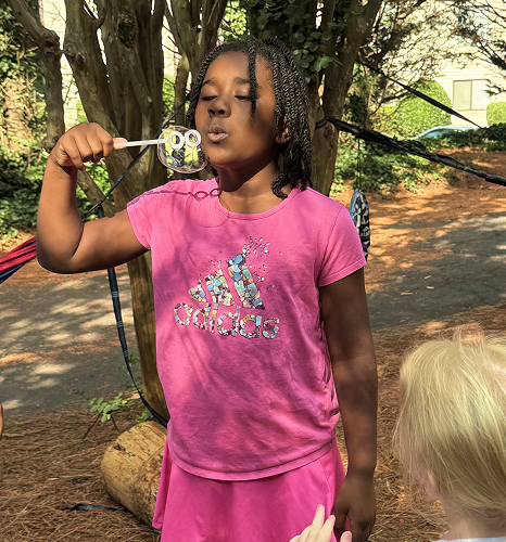 happy camper blowing bubbles