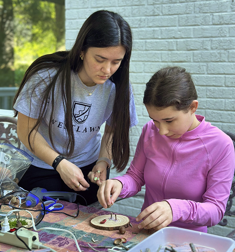 student and teacher crafting together 