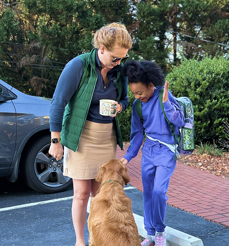 excited student petting a dog