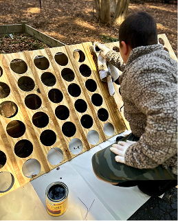 student staining wood